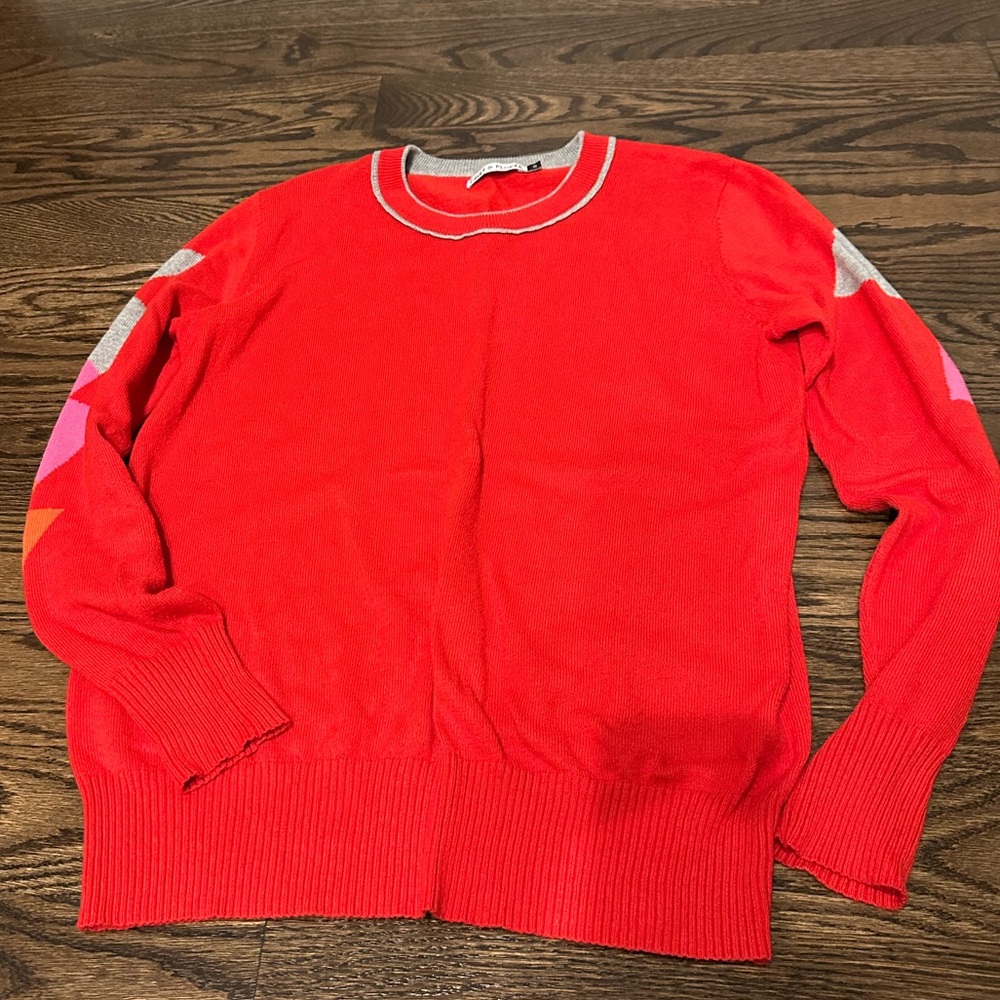 Red sweater w/ lightning bolts on arm